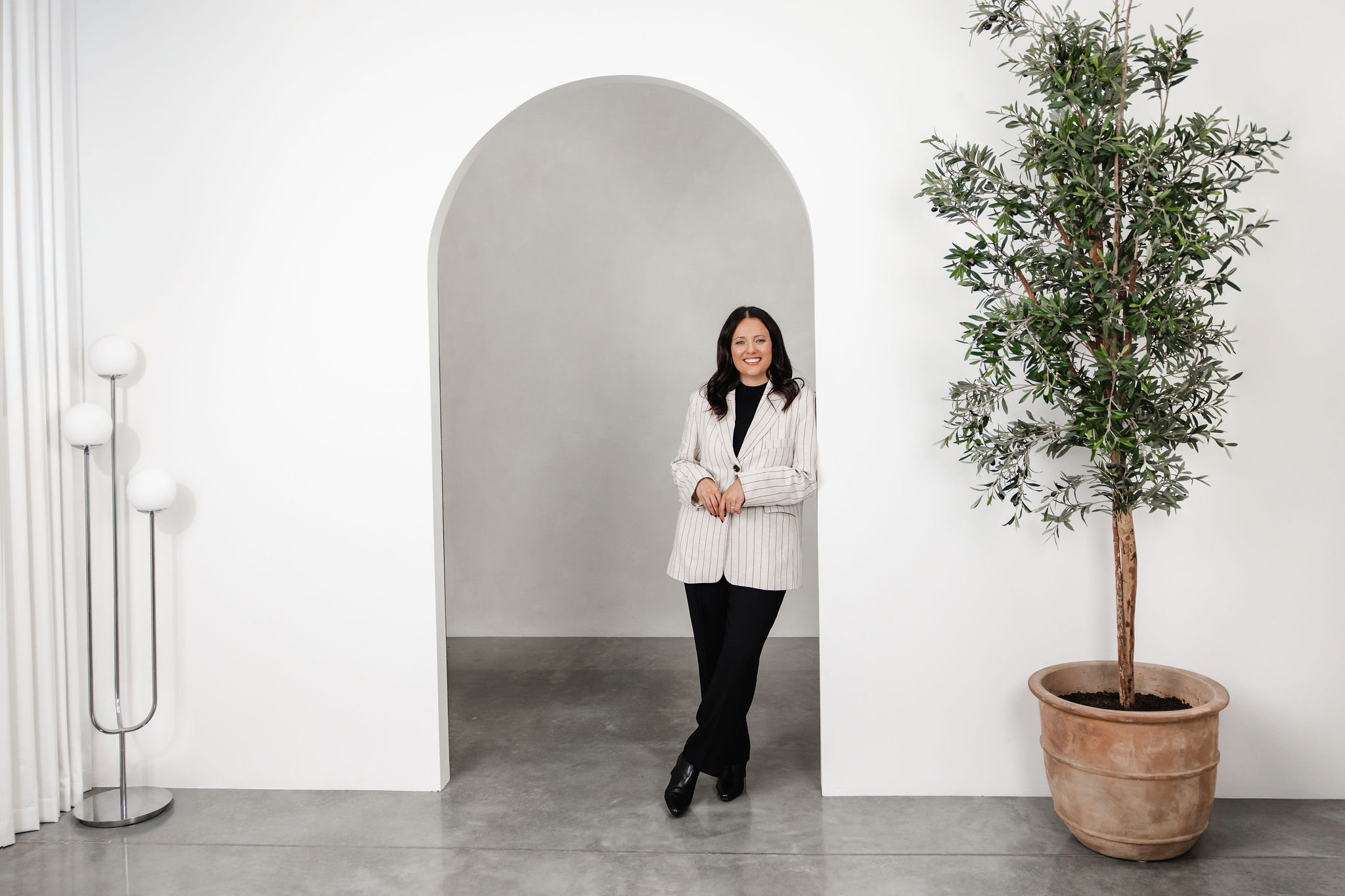 Karen, former Big 4 banker and refinancing specialist, standing in a bright, minimal studio